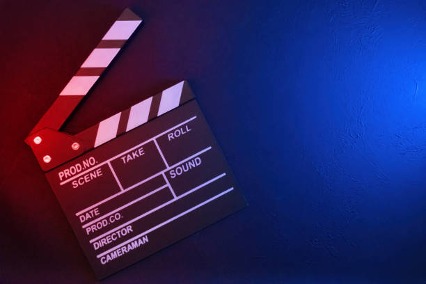 istock Clapperboard on black background with red and blue light, top view 2184241228