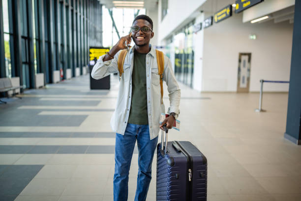 istock Traveler talking on phone at modern airport terminal. 2184241616
