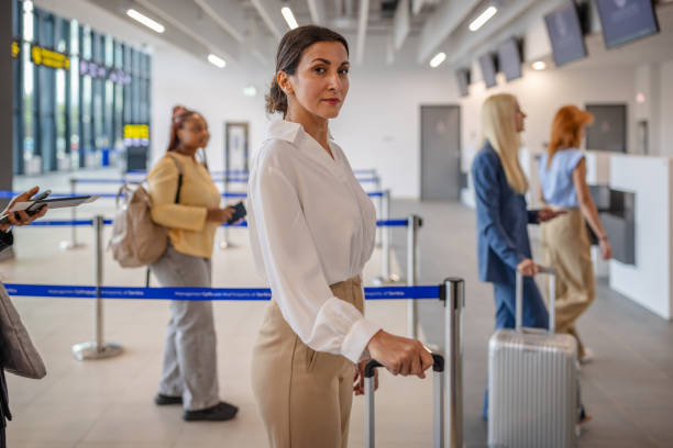 istock Traveler with suitcase waiting in line for check-in 2184241973