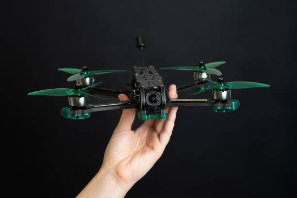 istock Professional modern drone with digital camera in hand on black background 2184243696