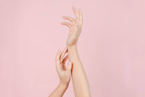 istock Manicured nails, beautiful woman hands forming an elegant shape on pink background 2184243776