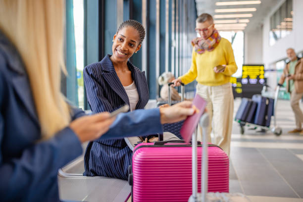 istock Airport lounge scene with passengers and rolling suitcase. 2184245321