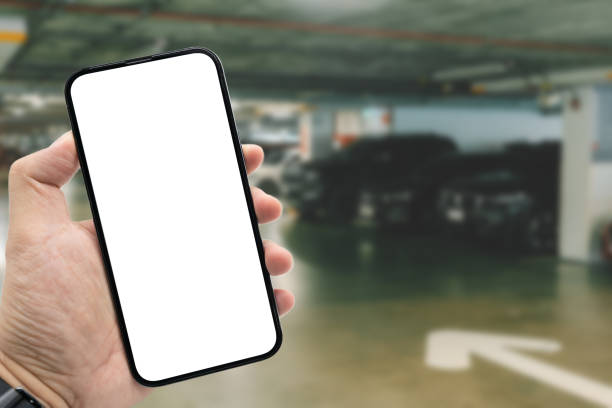 istock Mockup blank screen mobile phone for app or web site mockup. Smart phone with white screen in hand on Blur car parking background. 2184246082
