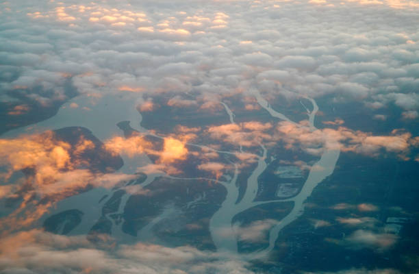 Aerial view of river and floating cloud under golden sunlight