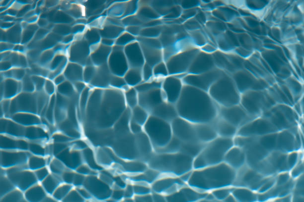 istock Blue water with ripples on the surface. Defocus blurred transparent blue colored clear calm water surface texture with splashes and bubbles. Water waves with shining pattern texture background. 2184247548
