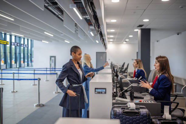 istock Busy check-in area with travelers and staff interacting 2184249411