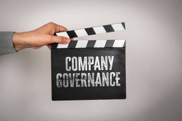 istock Company governance. Hand holding movie clapper 2184249425
