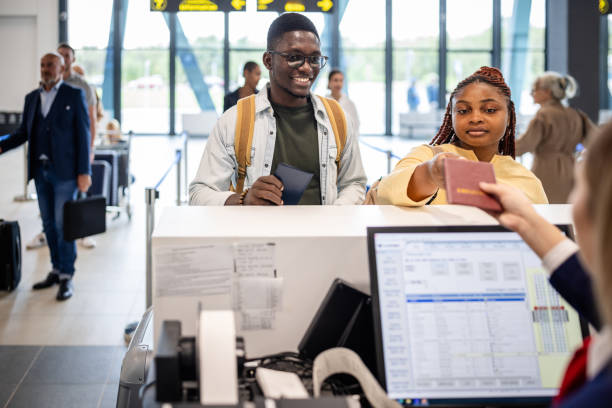 istock Couple presenting documents at airport check-in 2184252128