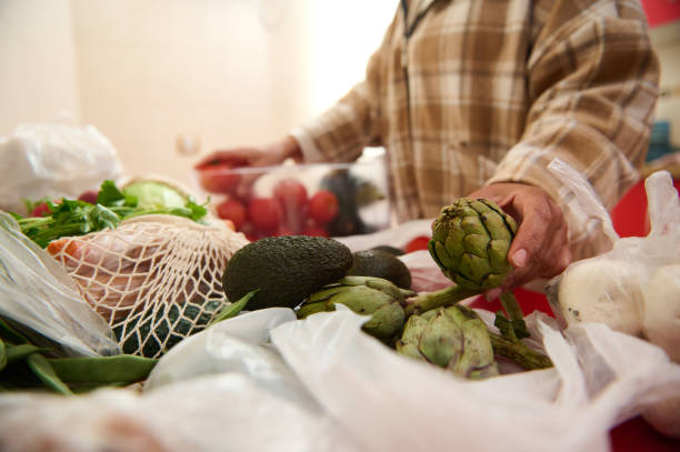 istock Person selecting fresh vegetables at a market stall 2184252243