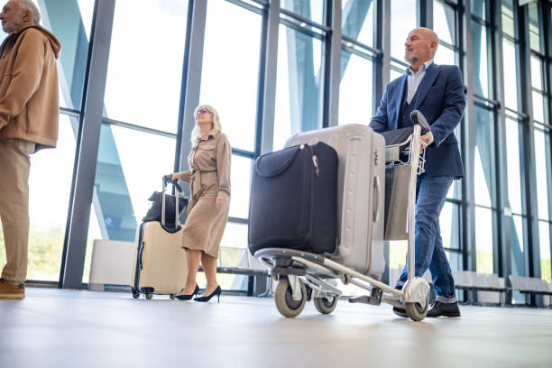 istock Travelers with carts in a sleek airport setting 2184253918