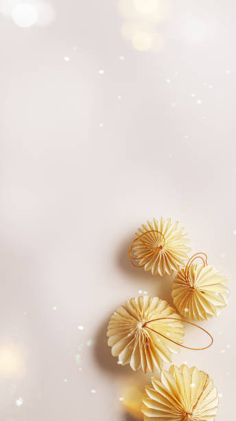istock Minimal style winter holidays top view composition with New Year paper festive ornaments beige Christmas balls on light background, light effects, copyspace. Neutral gentle tones, phone format 2184256604