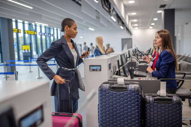 istock Woman engaging with airline staff at check-in counter 2184258556