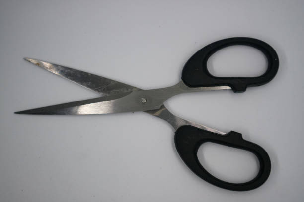 istock A pair of stainless steel scissors with black plastic handles 2184260806