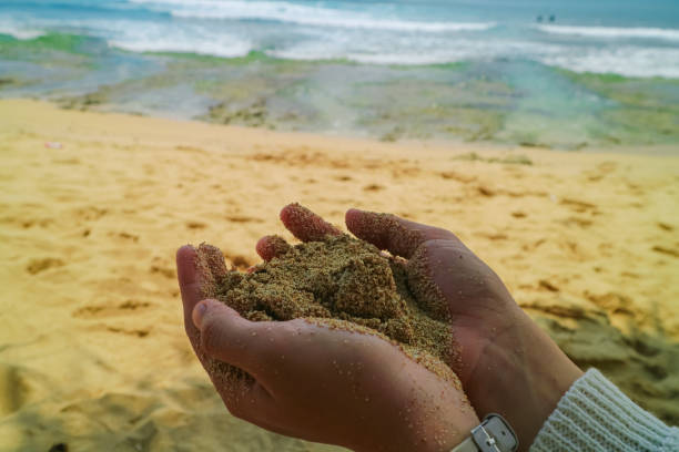 istock A pair of hands cupping soft sand on a beach 2184261751