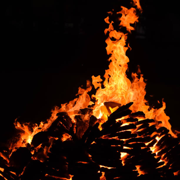 istock Fire flames on black background, Blaze fire flame texture background, Beautifully, the fire is burning, Fire flames with wood and cow dung bonfire 2184265114