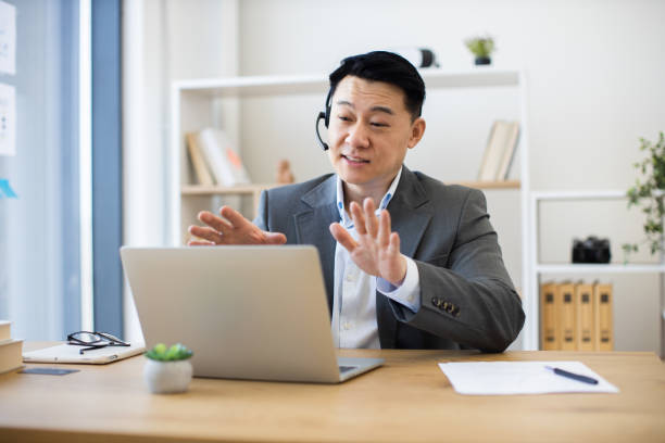 istock Asian businessman using laptop for video call in modern office 2184270270