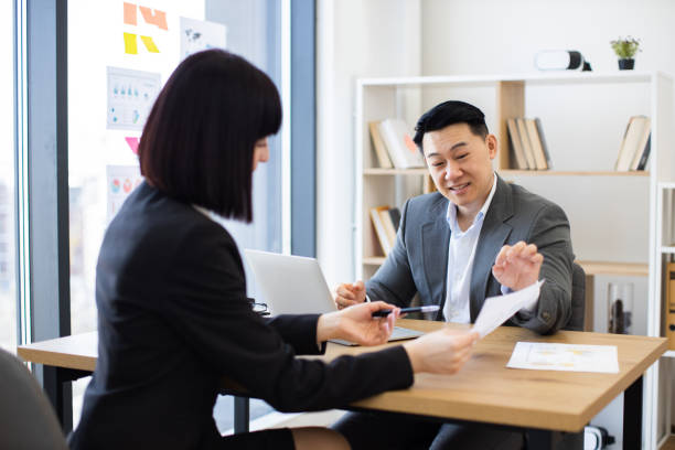 istock Business interaction in modern office setting with diverse professionals 2184270315