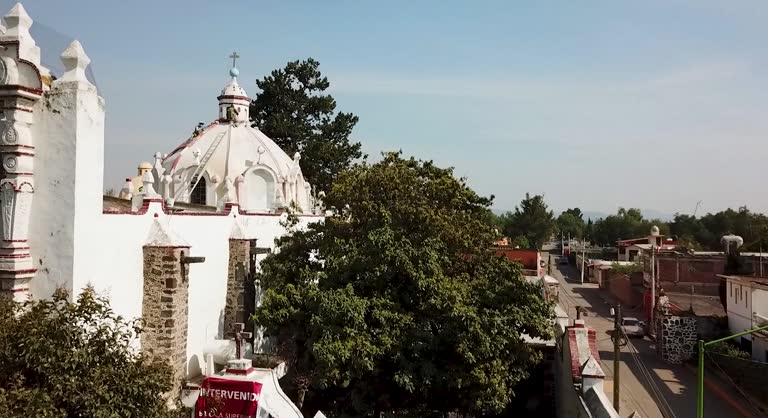 Drone footage path starting from the atrium and capturing an aerial view of the dome of the Parroquia de San Lucas Evangelista in the State of Mexico during an architectural intervention