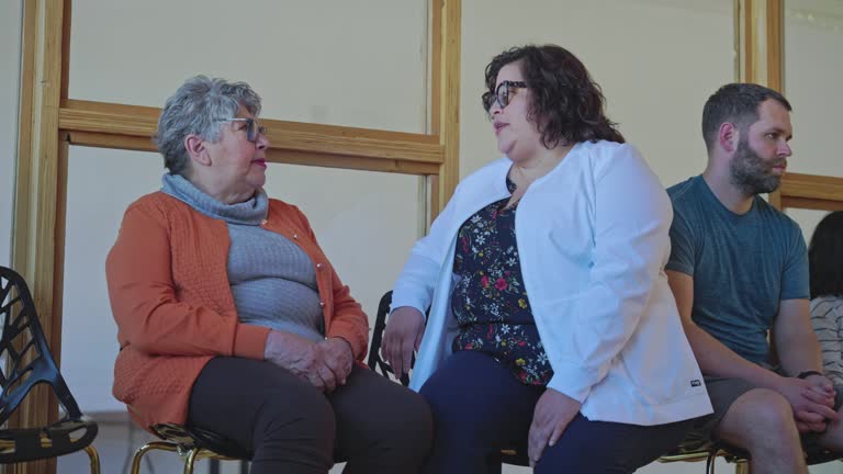 Senior woman talking with doctor in hospital waiting room