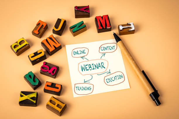 istock Webinar concept. Notepad and wooden alphabet letters on a light background 2184275340