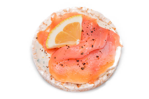 istock Rice Cake Sandwich with Fresh Salmon and Lemon - Isolated on White 2184280619