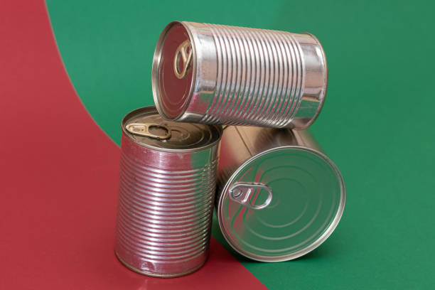 istock A Group of Stacked Tin Cans on Split Red and Green Background 2184286629