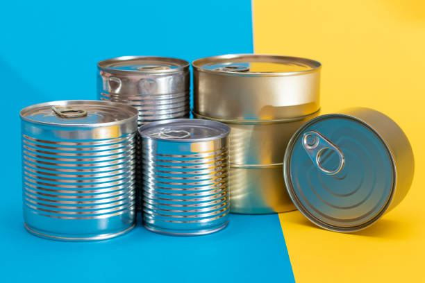 istock A Group of Stacked Tin Cans on Split Blue and Yellow Background 2184286803