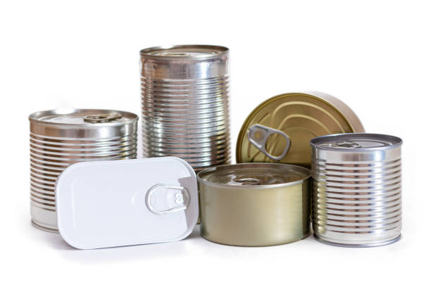 Wide angle view of tins of food of different sizes, colors and shapes isolated on white background.