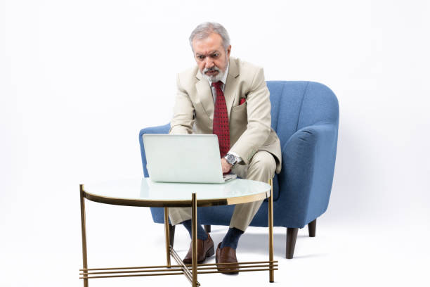 istock Senior man using laptop studio shoot stock photo 2184287494