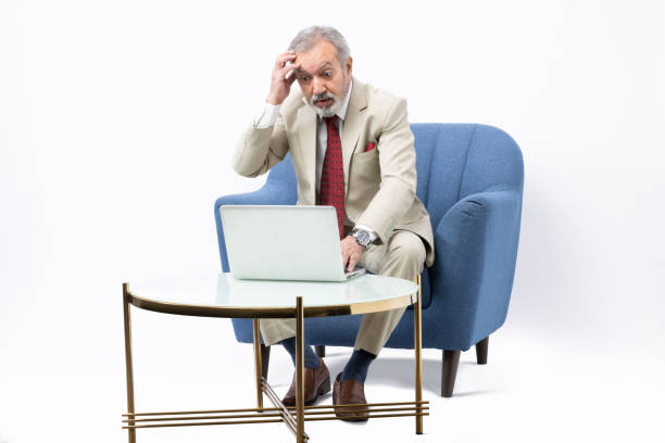 istock Senior man using laptop studio shoot stock photo 2184287515