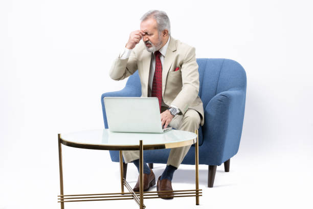 istock Senior man using laptop studio shoot stock photo 2184287528