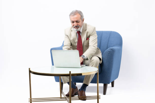 istock Senior man using laptop studio shoot stock photo 2184287807