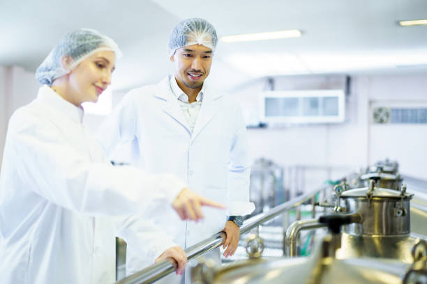 istock Quality control officer are examining in beverage manufacturing factory. 2184290086