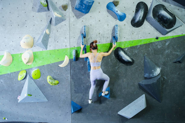 istock Asian sportswoman practices an indoor rock climbing wall. 2184290108
