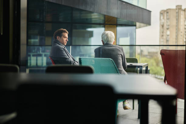 Two entrepreneurs talking during a break on a patio.