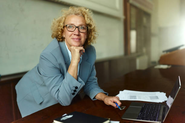 istock Pensive mature professor using laptop in a lecture hall. 2184291334