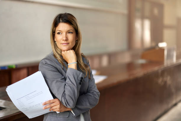istock Pensive female professor in lecture hall. 2184291960