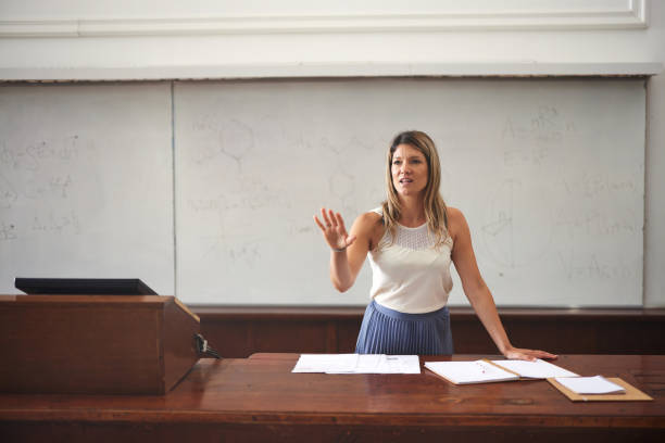 istock Female professor giving a speech in the classroom. 2184292081