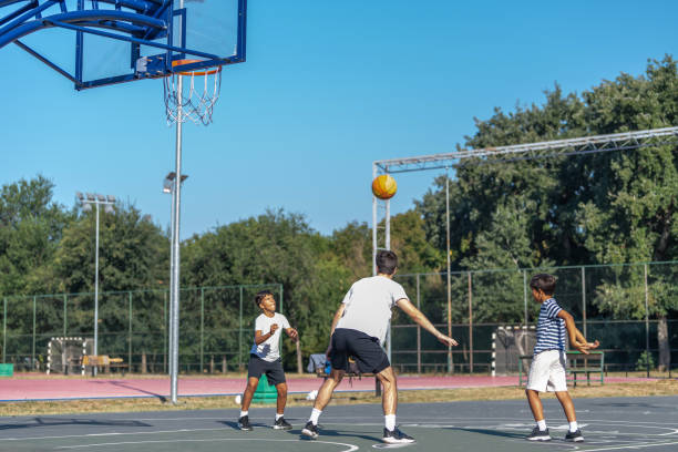 istock Boys engage in an outdoor basketball training session led by a coach, practicing techniques and building teamwork. The coach instructs them in skills, fostering discipline and fitness in a fun setting 2184293253