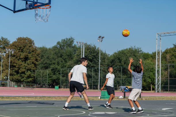 istock Boys participate in outdoor basketball training with a coach, focusing on skill development, teamwork, and fitness in a fun, structured environment, enhancing their athletic skills and confidence 2184293301