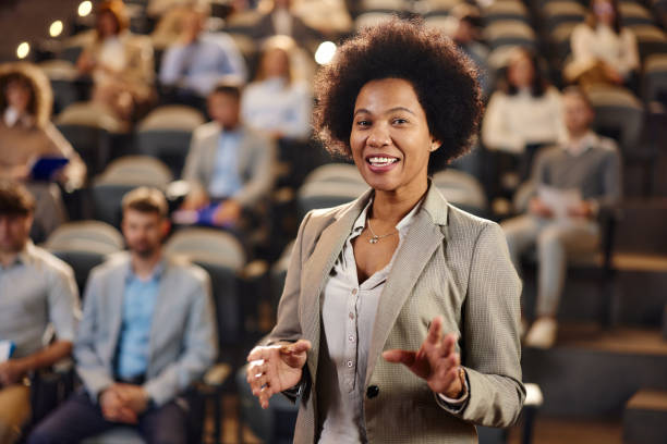 istock Happy black public speaker talking on education event. 2184293886