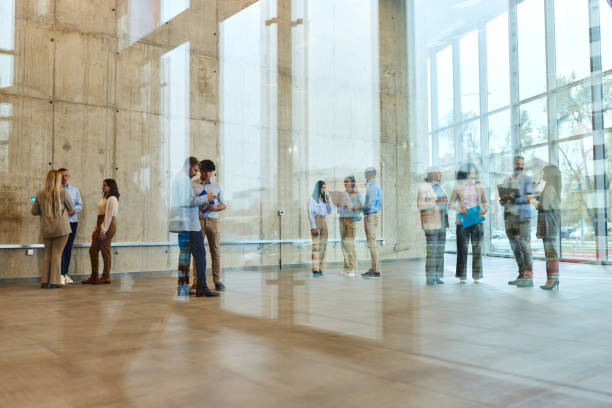 istock Large group of multi-tasking entrepreneurs in a hallway. 2184293904