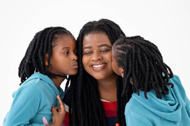 istock Studio shot of a mother and her twin daughters 2184296637