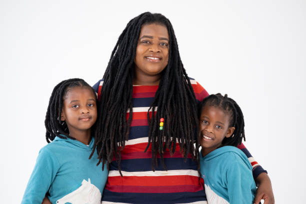 Young adult woman with braids hair looking at camera, studio shot