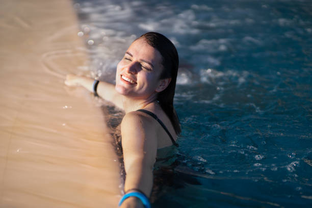 istock Woman Soaking in a Warm Pool with Winter Sunshine 2184297359