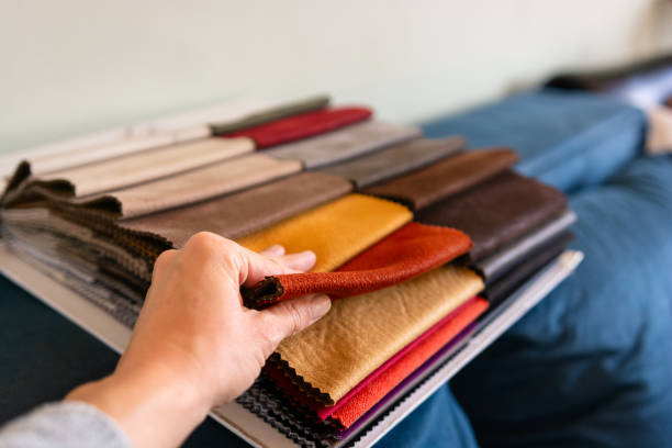istock The woman chooses the fabric on the sofa 2184298606