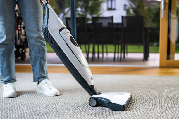 istock Person Cleaning Home with Vacuum Cleaner 2184298834