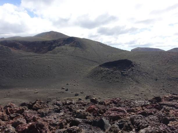 istock Volcanic landscape with rugged terrain and cloudy sky. 2184299766