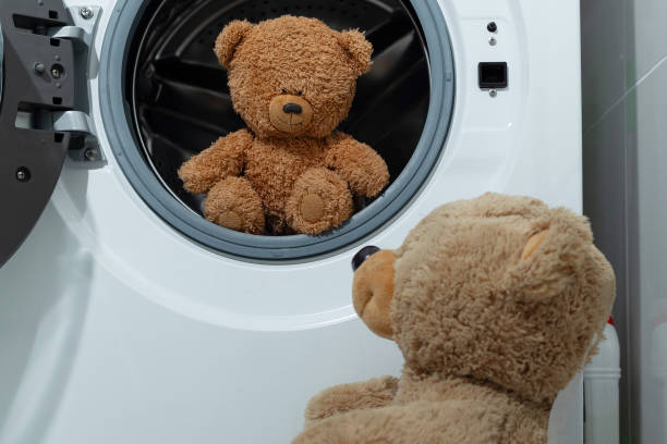 istock Adventurous Teddy Bears enjoy a fun time in a Washing Machine as they get clean 2184301010
