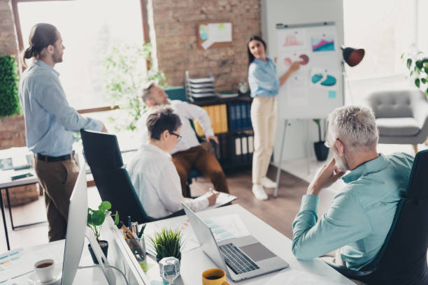 istock Full body photo of teamwork people working together graph trading discussion comfortable modern office loft room interior indoors workspace 2184301902